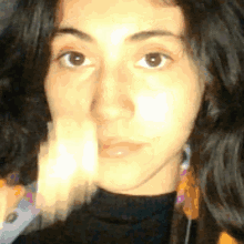 a close up of a woman 's face with a black shirt