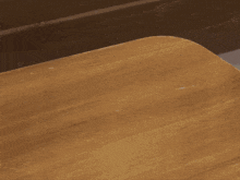 two hands are reaching out to touch each other on a wooden surface