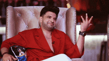 a man in a red shirt sitting in a chair