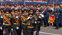 a group of soldiers marching in a parade with a flag that says ' russian federation ' on it