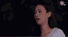 a close up of a woman 's face with the number 17 in the corner