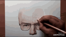 a person is drawing a man 's face with glasses on a piece of paper made in animatica