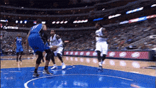 a basketball game is being played in a stadium sponsored by coca-cola
