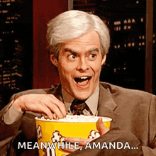 a man in a suit and tie is holding a yellow bucket of popcorn and saying meanwhile amanda