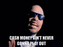 a man wearing sunglasses and a bow tie says cash money ain 't never gonna play out .