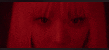 a close up of a woman 's face with blood on her face