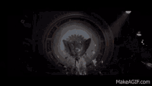 a person is flying through the air in a dark room with wings .