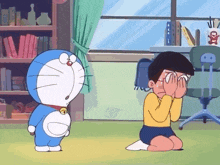 a cartoon of doraemon standing next to a boy covering his eyes