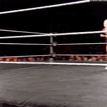 a wrestler in a ring with the next thing written on the bottom right