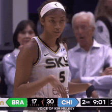 a female basketball player wearing a number 5 jersey