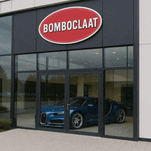 a blue bugatti is parked in front of a bomboclaat store