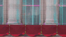 a building with columns and a balcony with red flags