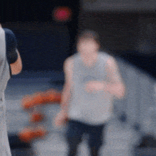 a blurry photo of a man in a tank top