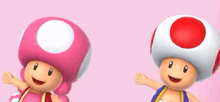 two toads are standing next to each other on a pink background . one is pink and the other is red .