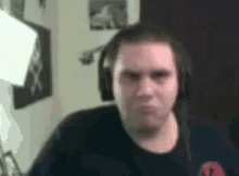 a man wearing headphones is making a funny face in a blurry photo