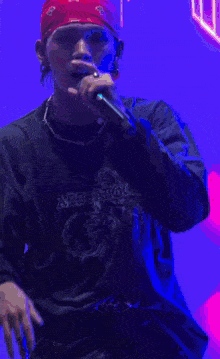 a man wearing a red hat and a black shirt that says ' i 'm sorry ' on it