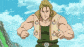 a man in a green tank top and a white vest is standing in front of mountains .
