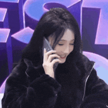 a woman in a fur coat is talking on her cell phone