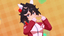 a girl with black hair is making a heart with her hands .