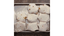 a bunch of tortilla wraps on a pan on a table