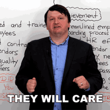 a man in a suit stands in front of a white board with the words they will care on it