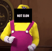 a man in a mario costume has a black square in front of his face that says " not elon "