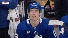 a hockey player wearing a blue jersey with the number 14 on it