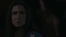 a close up of a woman 's face in a dark room