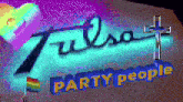 a neon sign for tulsa party people is lit up