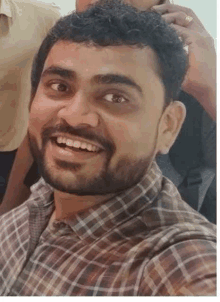 a man with a beard and mustache is smiling for the camera .