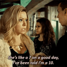 a woman talking to a man with the words she 's like a 7 on a good day