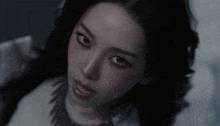a close up of a woman 's face with the letter s on the bottom left