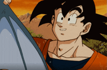 a cartoon character named goku is smiling and holding a piece of paper