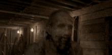 a blurred image of a person 's face in a dark room with wooden beams