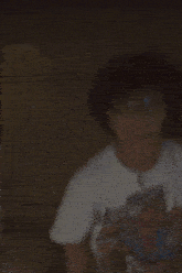 a blurry picture of a person wearing glasses and a spider-man t-shirt .
