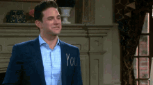 a man in a suit has the word you written on his back