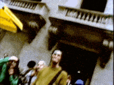 a group of people are standing outside of a building