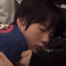 a close up of a person holding a child in their arms .