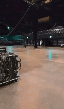 a large empty auditorium with a bunch of wires laying on the floor