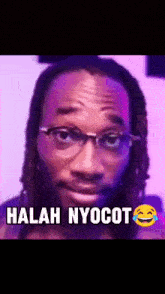 a man wearing glasses and dreadlocks is making a funny face with the caption " halah nyocot " .
