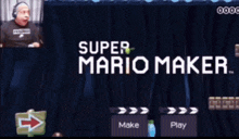 a video game called super mario with a hand holding a pen
