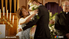 a bride and groom are kissing in a church with nbc written on the bottom