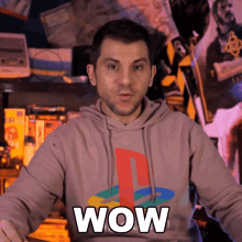 a man wearing a hoodie that says wow