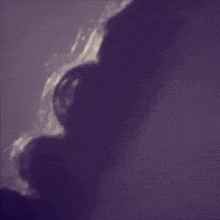 a purple background with a silhouette of a person 's head