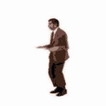 a man in a suit and tie is dancing on one leg .