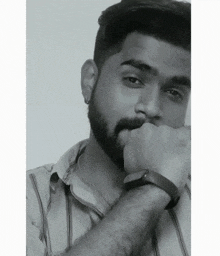a black and white photo of a man with a beard