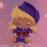 a stuffed doll with blonde hair and a blue hat is sitting on a pink surface .