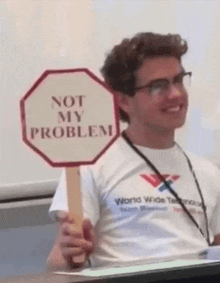 a man holds a sign that says not my problem