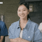 a woman wearing a blue jacket with the letter b on it