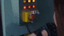 a woman with red hair is talking on a phone in a dark room .